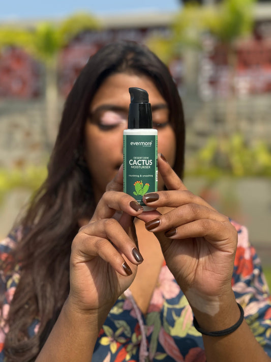Indian woman with vitiligo smiling while applying Evermore skincare product